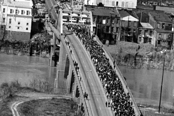 In this March 21, 1965, photo, civil rights marchers cross the Alabama River on the Edmund Pettus Bridge in Selma, Ala., toward the state capital of Montgomery.